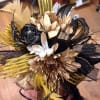 Black, gold, and white floral hair accessory with feathers