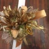 Gold-toned floral corsage with ribbon and mesh accents