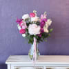 Soft magenta peonies and roses create an immediate joyful impact-an upright, garden-style