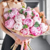 Bouquet of pink and white peonies wrapped in pastel paper