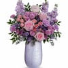 What a treat! Overflowing with pink roses and lavender blooms, this stunning
