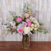 A soft, garden-style bouquet in pastel pinks, lavenders, whites and powder blue-perfect