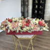 Long floral box arrangement with roses, hydrangeas, and pomegranates