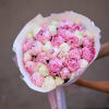 Bouquet of pink and white peonies wrapped in white paper