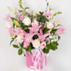 Pink lilies and white roses in a pink hatbox with ribbon