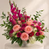 A lush, statement arrangement filled with rich pinks, peach tones, and layered