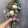 A soft and elegant arrangement featuring creamy peonies, delicate baby&rsquo;s breath, and