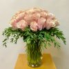 Bouquet of pale pink roses in a clear glass vase