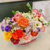 Colorful mixed flower arrangement in a clear glass vase