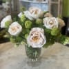 Two dozen Antonia Garden roses loosely arranged in a footed glass urn.