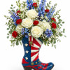 A fun and eye-catching floral arrangement designed in a decorative cowboy boot