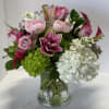 Pink and white floral arrangement in a clear glass vase