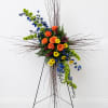This is a modern, artistic standing floral arrangement displayed on a metal