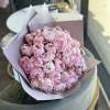 Bouquet of pink peonies wrapped in pale pink paper