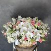 Large basket arrangement of white orchids, pink roses, and white spray flowers