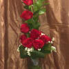 Tall bouquet of red roses in a clear glass vase