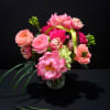 A lush cluster of pink, peach and white blooms arranged for maximum