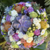 Round bouquet with roses, succulents, and orange pincushion blooms