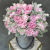 Pink peony bouquet in a gray hatbox with silvery foliage