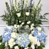 This arrangement surrounds the urn of your loved one with beautiful seasonal