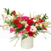 This arrangement feels romantic, joyful, and garden-inspired, with reds, pinks, and soft