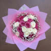 A classic arrangement featuring eighteen soft pink and white blooms arranged in