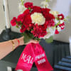 A classic arrangement of rich red roses with soft white accents for