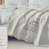 Soft, embroidered comfort designed to honor a mother's memory-this sympathy quilted throw