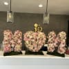 Large floral letter arrangements in pink, white, and lavender on moss bases