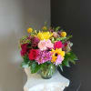 This beautiful flower arrangement of fresh mixed seasonal blooms is made by