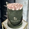 Round box of pale pink roses with ribbon handles