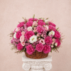 Basket arrangement of pink and white roses on a pedestal