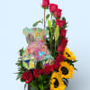 Tall red roses rise above a lively cluster of bright yellow sunflowers