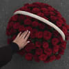 Basket filled with red roses and a white handle