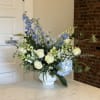 Blue and white floral arrangement in a white vase