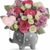 Pink and white roses in a gray polka-dot elephant planter with a 