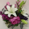 Purples, hot pink, and magenta blossoms are highlighted with a creamy Asiatic