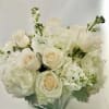 White roses and hydrangeas arranged in a square glass vase
