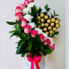 Pink roses and white carnations in a white hatbox with gold chocolates
