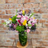 Pink and white bouquet in a green glass vase