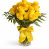 A radiant bouquet of premium yellow roses arranged in a clear vase