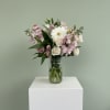 A delicate mix of soft pinks, creamy whites, and fresh greenery, arranged