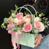 An elegant tote of lush pink rose, lisianthus and springy flowers.