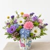 Whimsical, colorful, and full of charm, this cheerful arrangement is designed in