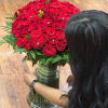 Large bouquet of red roses in a glass vase