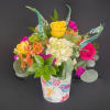 This vibrant arrangement is a cheerful garden party in a cup! It&rsquo;s