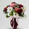 A stunning expression of grace and affection. This lush arrangement features deep