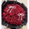 Bouquet of red roses wrapped in black paper with pearl bow accents