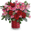 This Valentine's Day arrangement features red spray roses, pink alstroemeria, and miniature