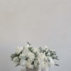 A timeless, elegant arrangement designed in soft neutral tones, featuring lush white